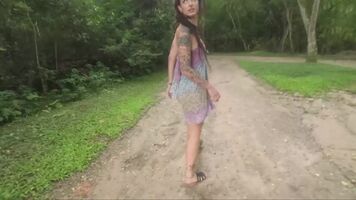 Tattooed beauty goes to the forest. She has a surprise in her ass!