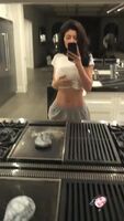 Kylie Jenner in white top, piercing visible, flat stomach, phat ass and extremely attractive!!! This is a MILF!!!!