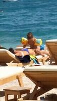 Kid humping his mom on the beach
